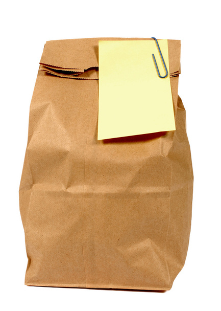 Brown paper lunch or groceries bag with yellow post it style sticky note - Photo, Image