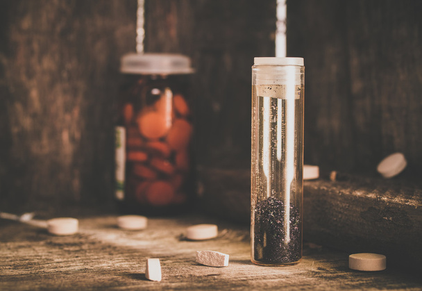 Manganese and tablets in jar on a shelf of old cobwebby. - Foto, afbeelding