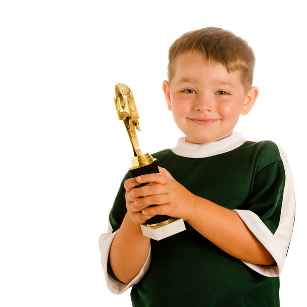 Happy child in soccer or football uniform with trophy isolated on white - Foto, afbeelding