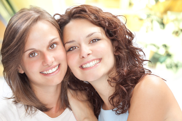 beautiful young girl couple hug smile in a interior background - Photo, Image