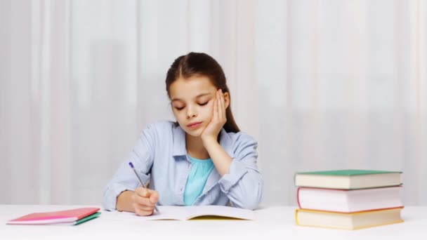school girl hand writing math task to notepad - Materiaali, video