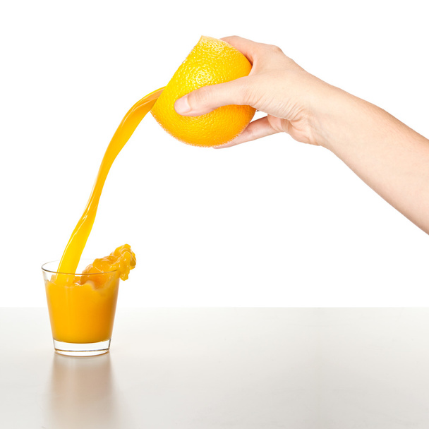 girl pour orange juice from a orange isolated on white - Фото, зображення