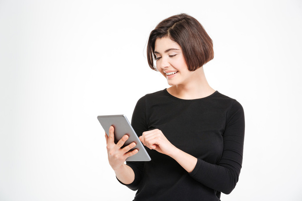 Smiling woman using tablet computer - 写真・画像