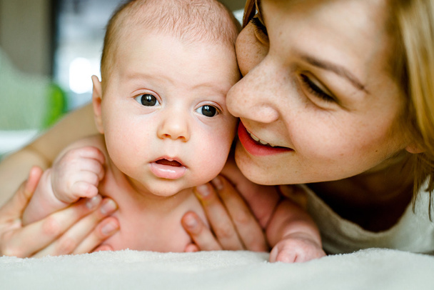 Portrait of happy mother and baby at home - Photo, Image