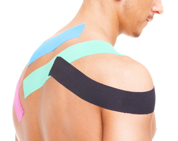 Muscular man with kinesiotaping on the shoulder - Foto, Bild