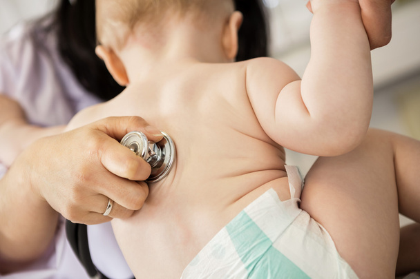 Pediatricians Hand Examining Baby Though Stethoscope - Fotografie, Obrázek