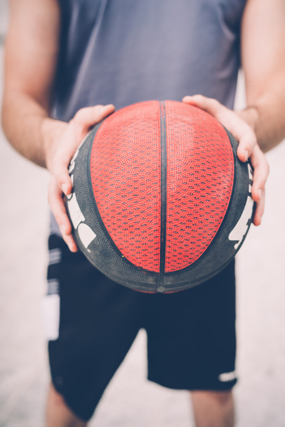 sportive man holding basket ball  - Fotó, kép