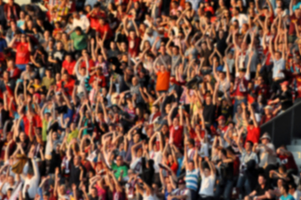 Crowd in a stadium. Blurred heads and faces of spectators - Photo, Image