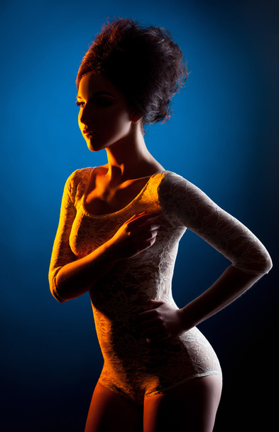 Studio shot of underwear model posing in spotlight - Φωτογραφία, εικόνα