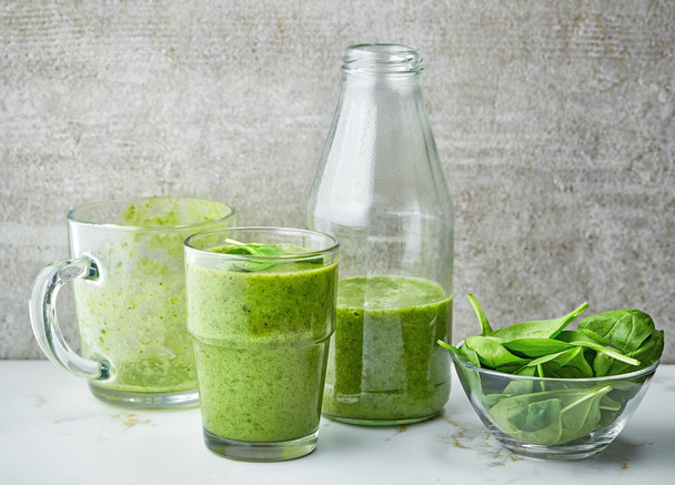 glass and bottle of green smoothie - Фото, зображення