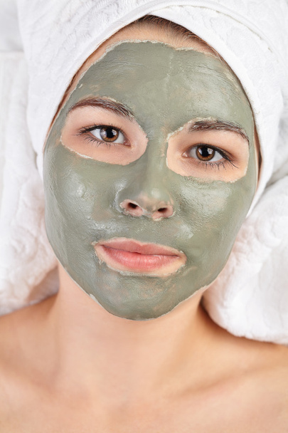 Attractive young woman with spa applied mud clay mask. - Foto, Imagem