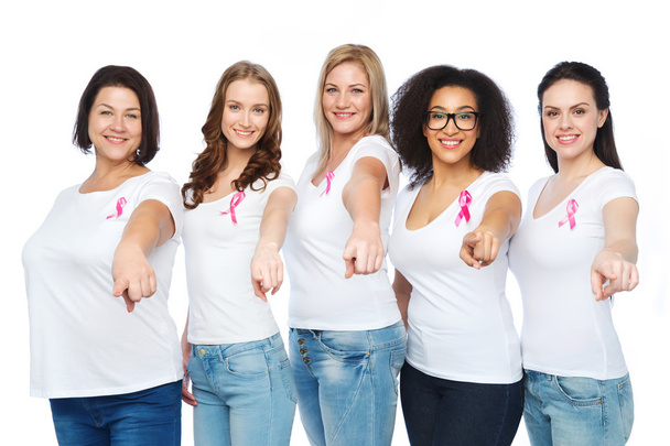 happy women with breast cancer awareness ribbons - Valokuva, kuva