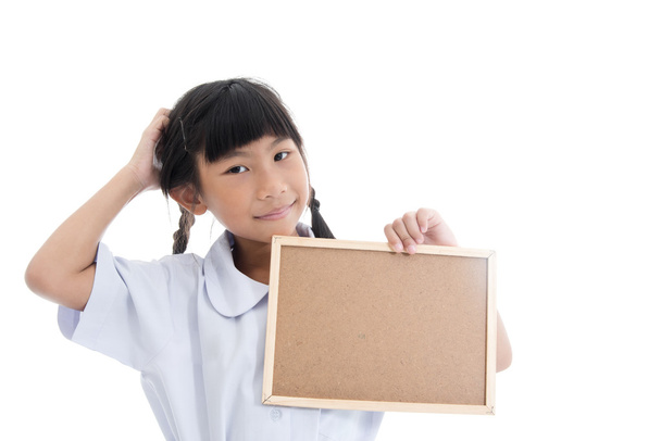 Asian girl scratching her head and holding corkboard on white. - Foto, immagini