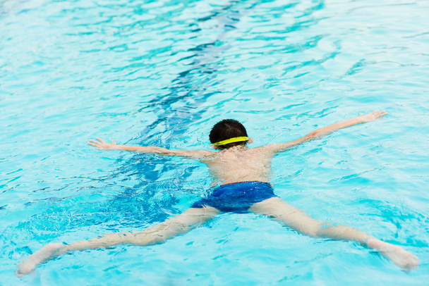 Swimming boy under water - Фото, зображення