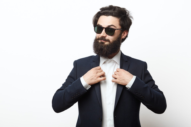 Portrait of happy hipster guy wearing a business black suit - Photo, Image