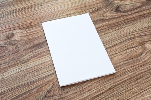 Blank of brochure is on a wooden desk. - Fotó, kép