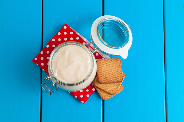 Homemade yogurt on a blue wooden table. - Foto, afbeelding