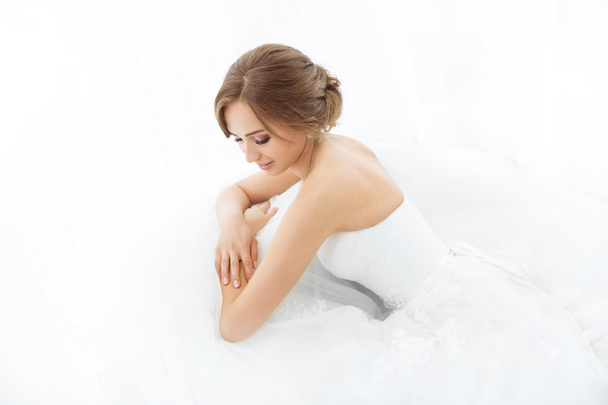 Brides beauty. Young woman in wedding dress indoors - Fotoğraf, Görsel