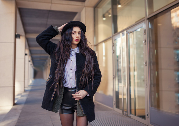 Портрет красивой молодой девушки, одетой в хипстерский гранж-стиль на городском фоне. В джинсах и шляпе. Женщина весенней моды. Тонированные фильтры Instagram
. - Фото, изображение