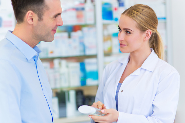 Pharmacist and client at pharmacy - Photo, image