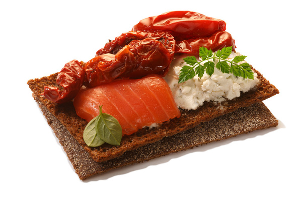 Bread crisp with salmon, soft cheese, dried tomatoes and chervil - Photo, Image