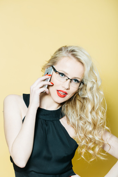 Sexy blonde in glasses with phone - Фото, изображение