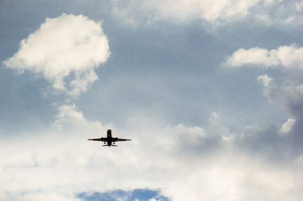 airplane flying in the blue sky with clouds - Fotó, kép