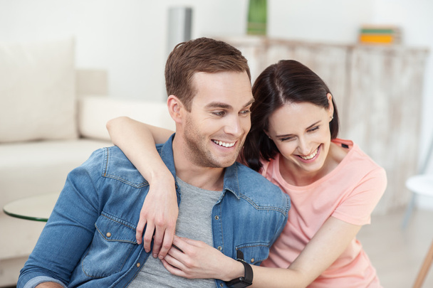 Cheerful loving couple is relaxing on flooring - Photo, Image