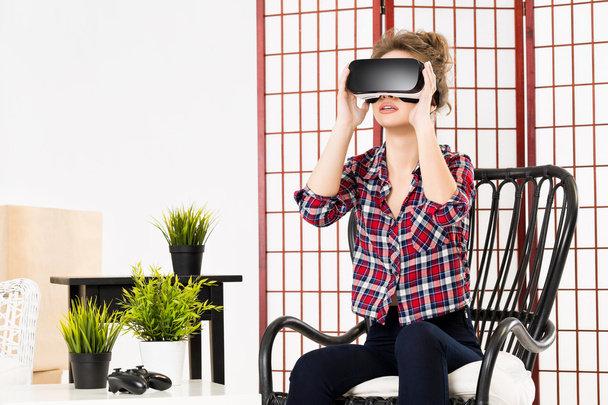 Girl getting experience using VR-headset glasses of virtual reality - Photo, image