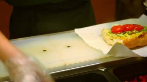 Fast food, prparing sandwich in transparent glowes - Кадри, відео