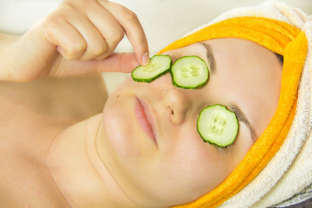 Closeup woman on face with cucumber - Valokuva, kuva