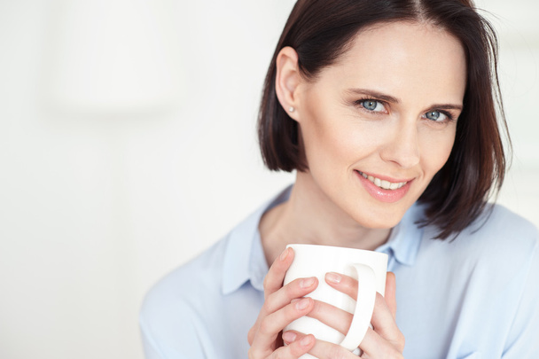 Beautiful woman is drinking adorable beverage - Photo, Image