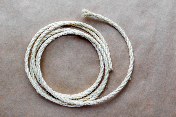rope coiled at kraft paper on the background - Foto, imagen