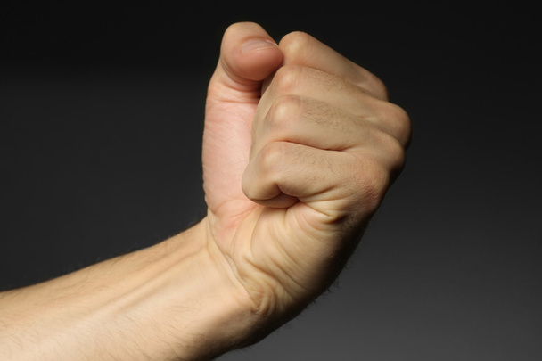 Male fist on grey   - Foto, Imagem