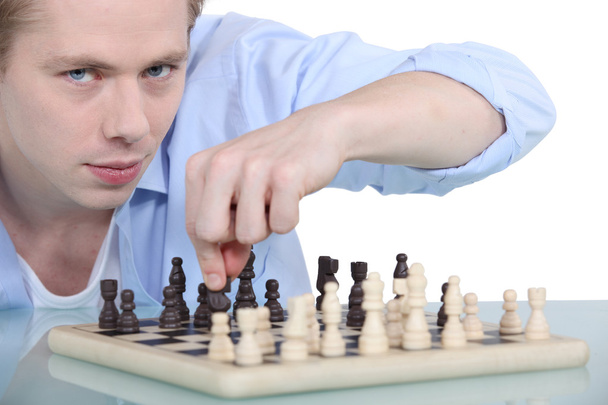 Young man playing chess - Zdjęcie, obraz
