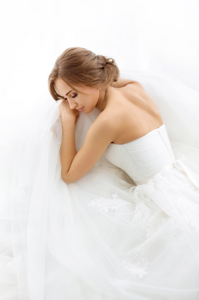 Brides beauty. Young woman in wedding dress indoors - Zdjęcie, obraz