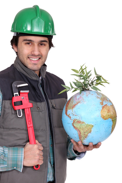 Man holding globe and wrench - Φωτογραφία, εικόνα