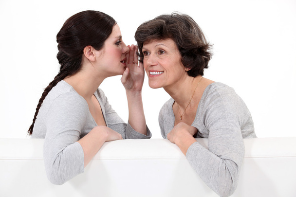 Woman telling her mother a secret - Foto, imagen