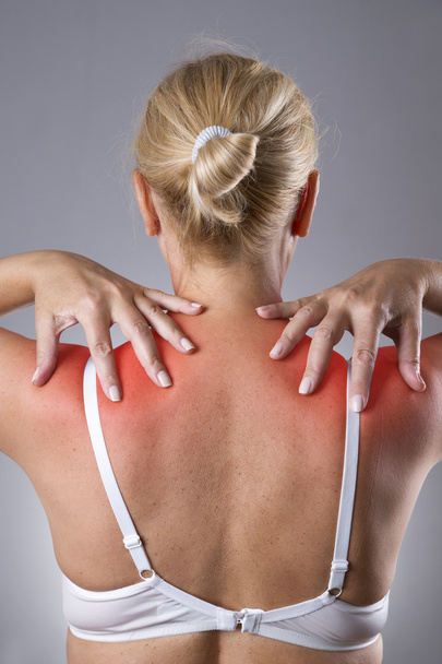 Woman with pain in shoulders. Pain in the human body with red dot - Фото, изображение