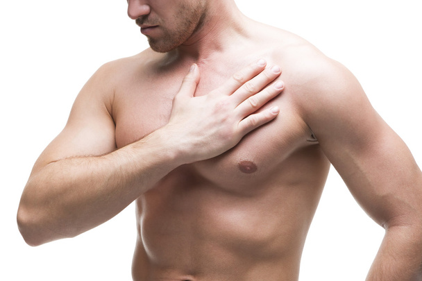 Heart attack. Young muscular man with chest pain isolated on white background - Foto, afbeelding