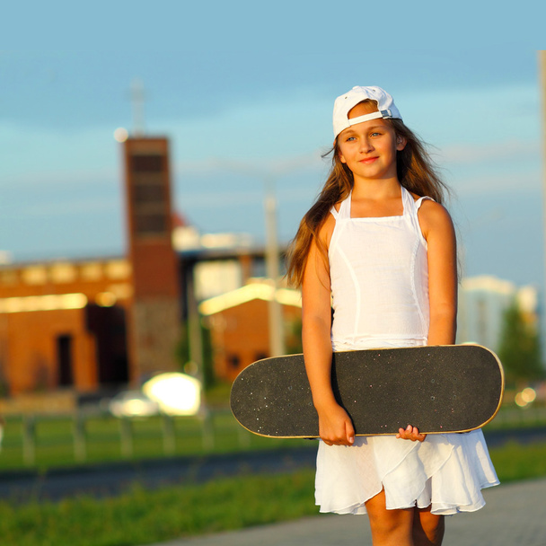  teen girl  with a skateboard  - Photo, Image