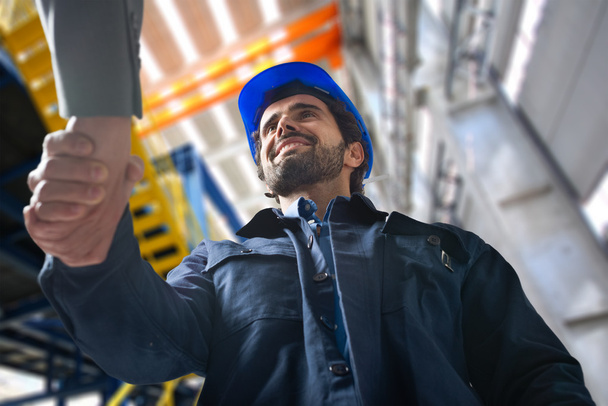 men shaking hands in an industrial facility - Photo, Image
