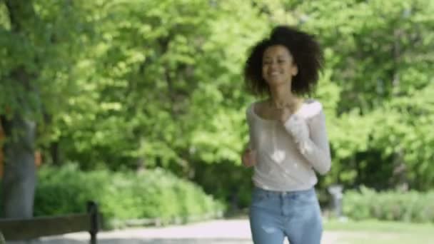 Closeup portrait of a beautiful cheerful mixed race woman running up to a camera. - Video, Çekim