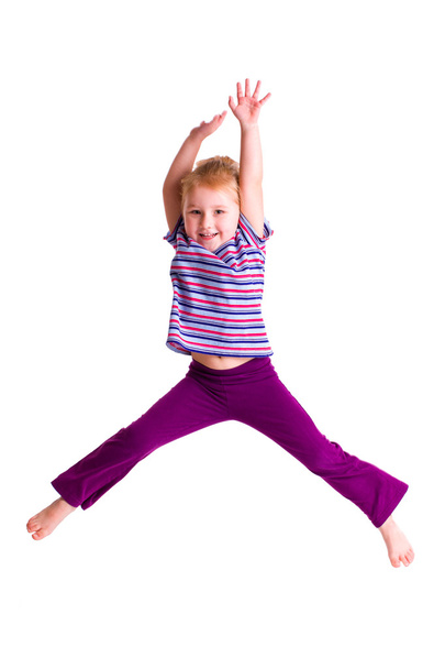 Studio shot of young girl jumping - Фото, изображение