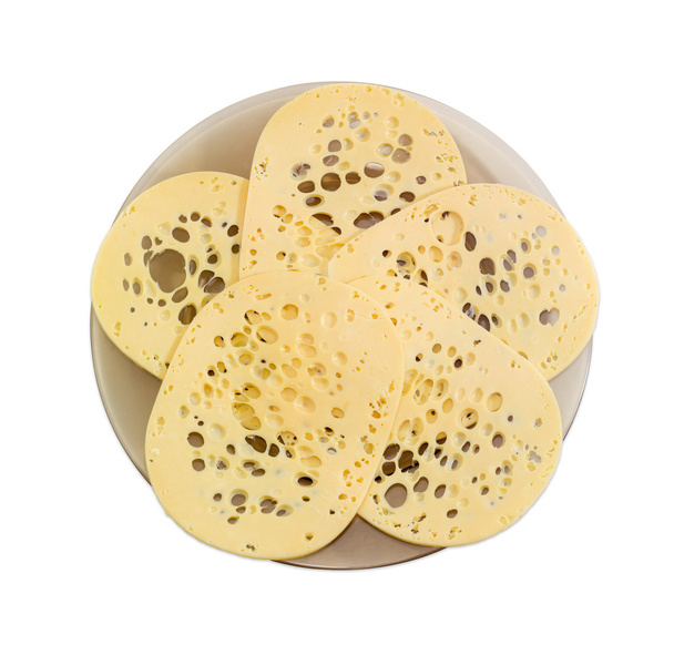 Нарезанный сыр швейцарского типа на стеклянной тарелке
 - Фото, изображение