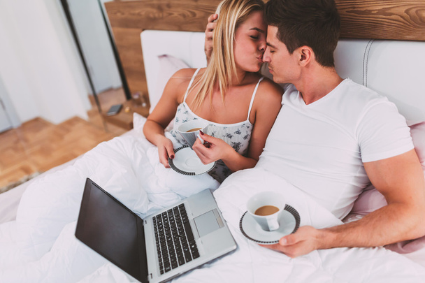 Couple relaxing in bed with coffee  - Φωτογραφία, εικόνα