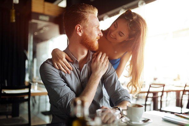 Beautiful man and woman in cafe  - Фото, изображение