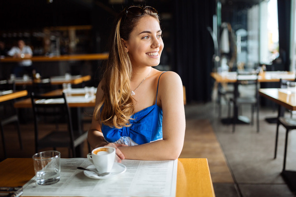Beautiful woman enjoying her coffee - Foto, immagini