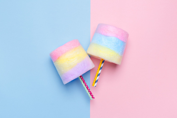 Minimal style. Multicolored Cotton candy. Pastel blue and pink background - Foto, Imagen