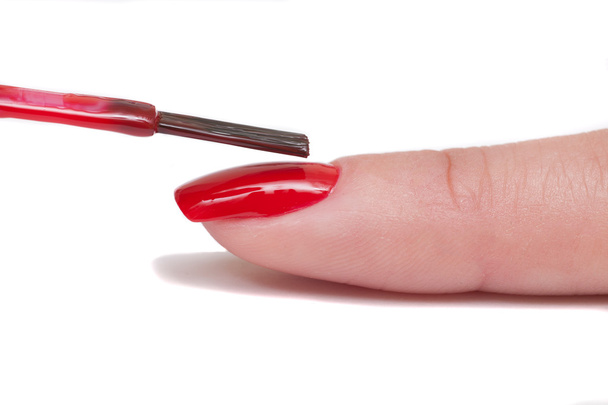 Professional manicurist makes the new red gel polish manicure - Photo, Image